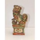 A 19thC Chinese Qing Dynasty Buddhistic lion incense burner, painted in rust red & green on a