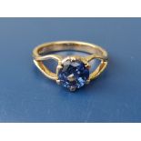A round cut sapphire solitaire claw set in 18ct yellow gold. Finger size L/M. The stone slightly