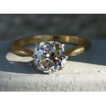 An old cut diamond solitaire ring, the square cushion shaped claw set stone weighing approximately