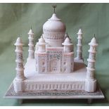 An alabaster model of the Taj Mahal, having carved, inlaid & painted details, 9".