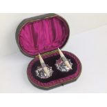 A cased pair of late Victorian ivory mounted silver carver rests - JD & S, Sheffield 1900. (2)