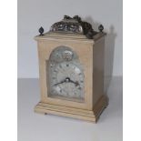 A 20thC bracket style mantel clock in limed wood case by Canham of London, 7" high excluding