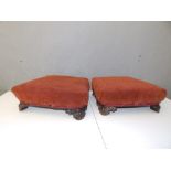 A pair of Victorian upholstered rosewood foot stools, of shaped rectangular form, 14" across.