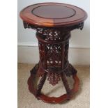 A Chinese carved wood circular pedestal table on openwork column to splayed base, 16" diameter.