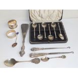 A cased set of six Birmingham silver teaspoons, two silver napkin rings and six other pieces. (14)