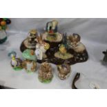 Nine Beatrix Potter Beswick characters and stand