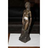 A cast bronzed resin standing nude femal