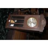 A 1930's /40''s oak wall clock, with Ara