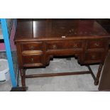 A 1920's oak knee hole writing desk, wit