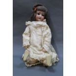 An early 20th century German bisque head Schoenau and Hoffmeister doll,