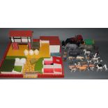 A wooden toy farm yard with accessories, a Britain's diecast tractor with trailer,