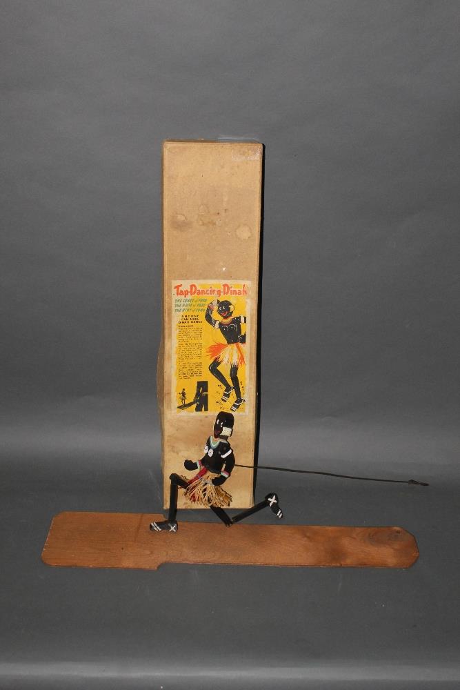 A 1930's/40's "Tap dancing dinah" wooden dancing figure, of a grass skirted African woman,