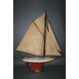 A wooden pond yacht, painted in white and red, with four sails, length 90 cm, and with stand.