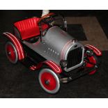 A Syot imitation delux Model T Ford Roadster pedal car in red and silver,