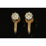 A pair of 9ct gold and diamond set solitaire earrings,