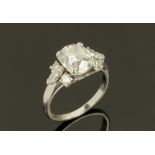 A Boodle & Dunthorne platinum and diamond set ring, the cushion cut central stone approximately 1.