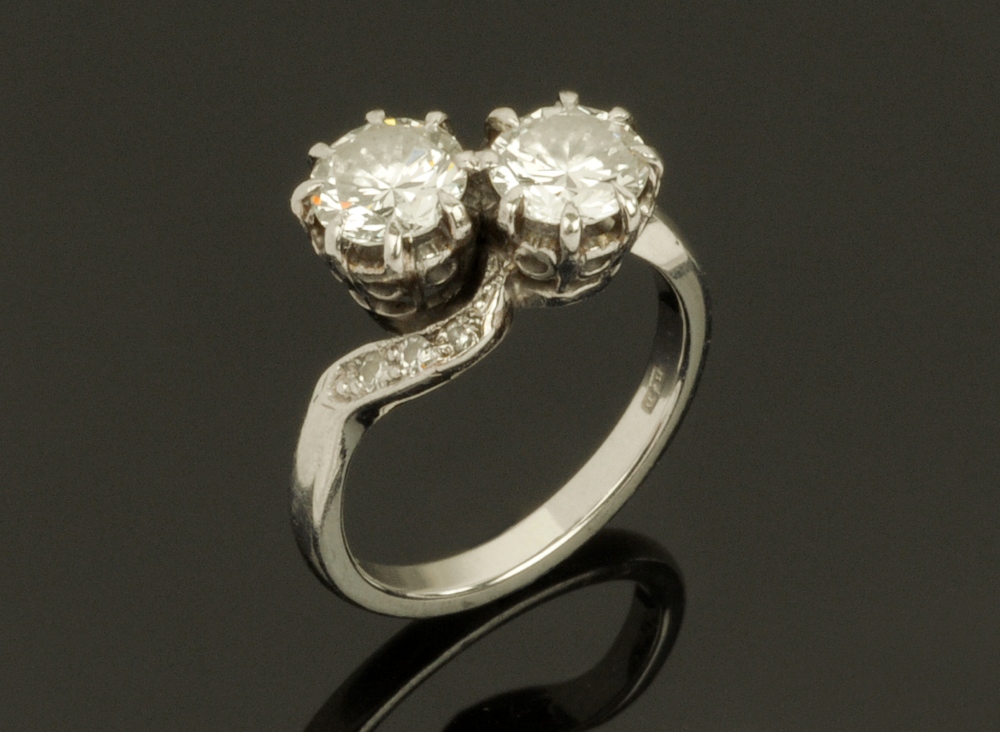 A Boodle & Dunthorne platinum and diamond set crossover ring,