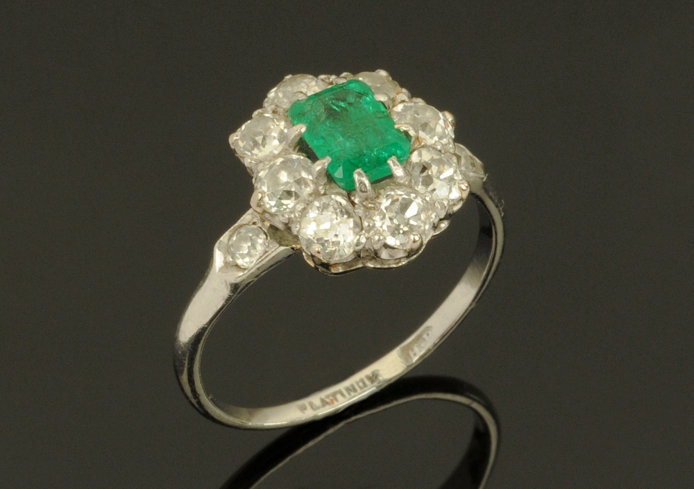 An early 20th century platinum diamond and emerald set ring,