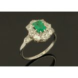 An early 20th century platinum diamond and emerald set ring,