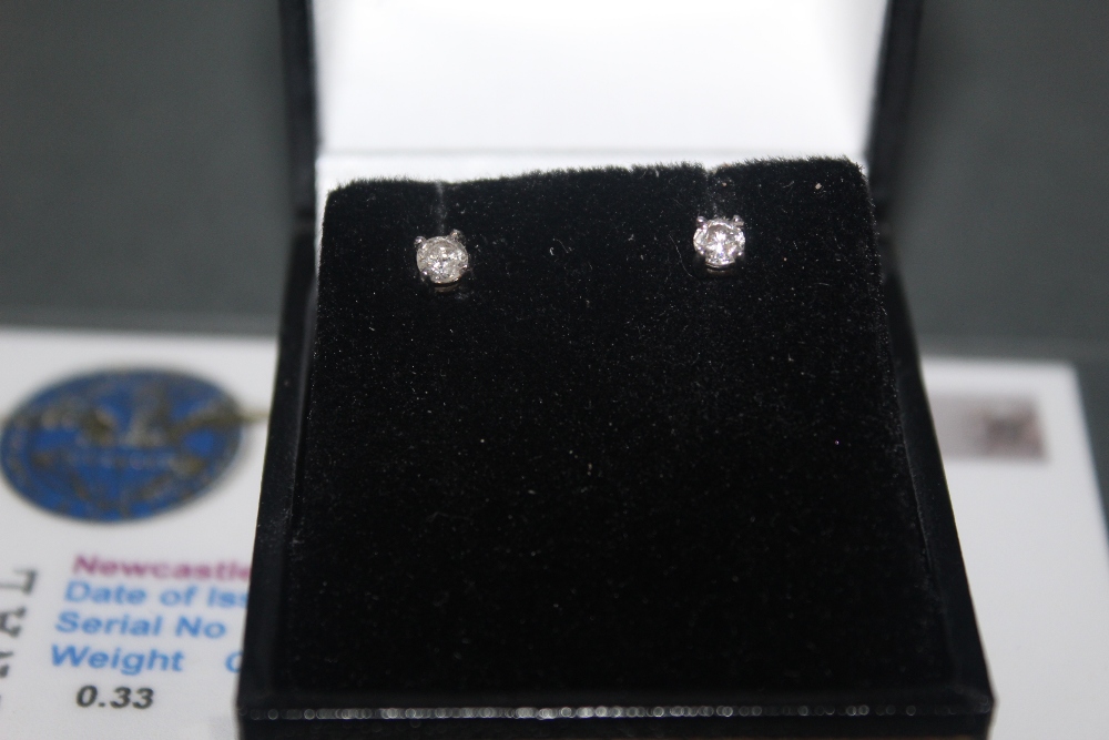 A pair of platinum and diamond stud earrings, combined approx weight 0. - Image 2 of 3