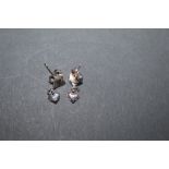 A pair of hammered silver stud earrings, of heart design with smaller heart shaped pendant drops.