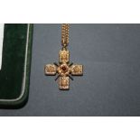 A British museum gilt metal and purple coloured paste, reproduction crucifix and chain,