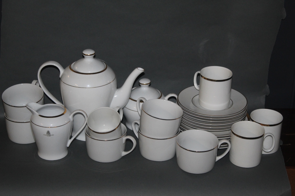 A continental gilt and white coffee set, with coffee pot, saucers, milk jug and sugar pot.