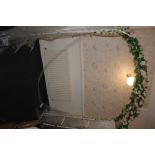 A modern white painted metal wedding arc