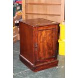 A mahogany cupboard with slot in shelves