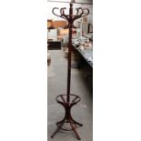 A mahogany finish six hook coat stand of