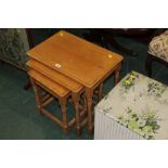 A nest of three light oak tables