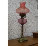 Antique oil lamp with red glass shade an