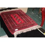 A red patterned prayer rug, 73 cm x 54 c