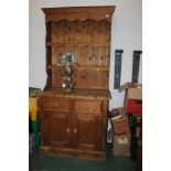 A tall pine dresser in two sections, hei