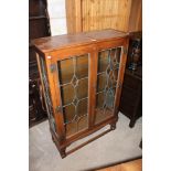 An oak display cabinet, fitted three pla