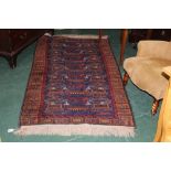 An Afghan rug, decorated in reds, orange and blues, depicting helicopters,