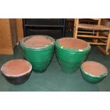 A pair of green painted circular planter