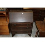 An Edwardian oak bureau of Arts and Craf