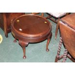 A circular mahogany occasional table wit