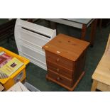 A pine three drawer bedside chest, and a