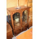 A rosewood finish display cabinet, fitte