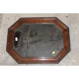 A 1930's oak octagonal wall mirror with