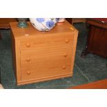 A lightwood three drawer chest of drawer