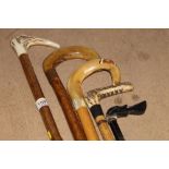 Two Antler handled walking sticks and th