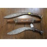 Two kukri knifes and a sheathed knife an