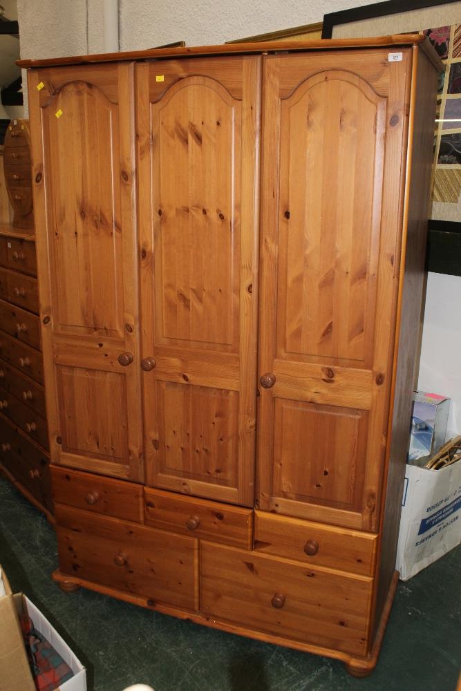 A large modern pine triple wardrobe, with three doors and five drawers, height 200 cm, width 124 cm,