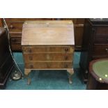 A walnut bureau raised on Queen Anne leg