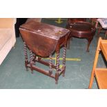 An oak drop leaf gate leg table