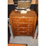 A 1940's walnut finished chest of drawer