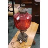 A lantern style electric lamp with red glass shade,